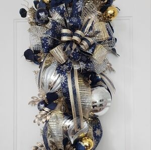 Navy Blue, Gold and Silver Christmas Swag with Silver and Gold Ornaments.